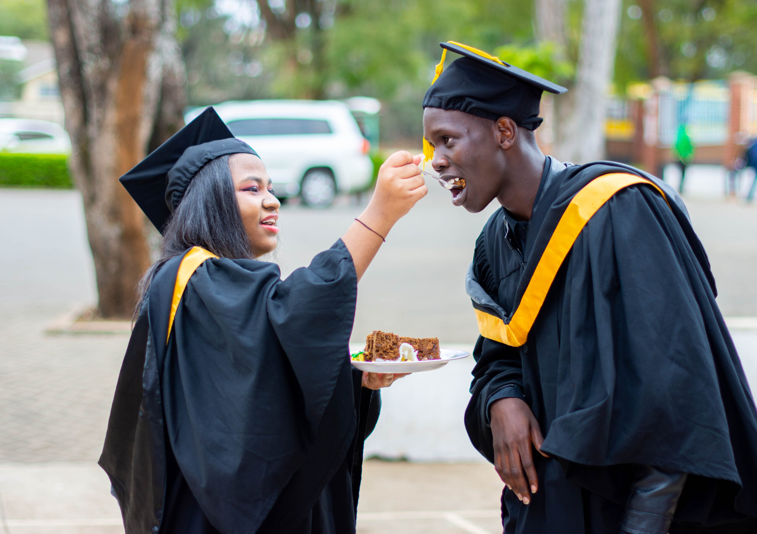 Graduands sharing a piece of cake